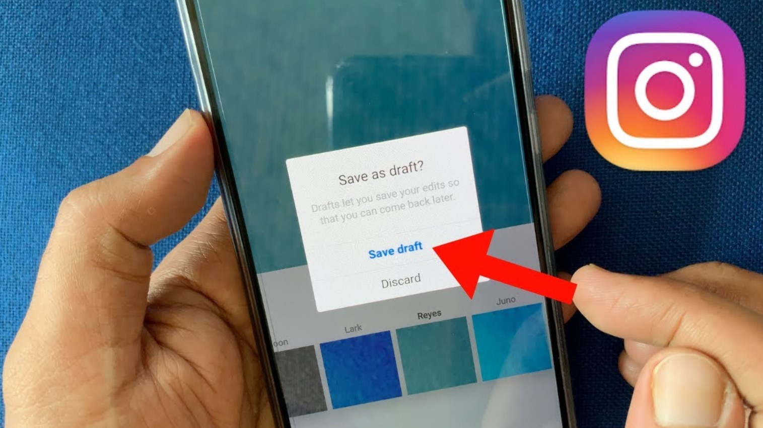  A hand holding a mobile phone with the Instagram app open and a pop-up window asking if the user wants to save a draft of their Instagram post.